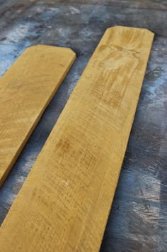 two pieces of wood sitting on top of a table