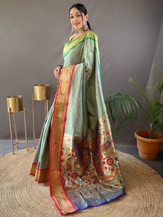 Wear this gorgeous grey paithani silk saree and be prepared to wow everyone around you! This stunning saree is made from high-quality silk material, ensuring a luxurious and comfortable feel against your skin. The saree features intricate zari weaving work, adding a touch of elegance and sophistication. The rich pallu with golden motifs all over the saree adds a regal and glamorous touch.
Not only does this saree come with a matching blouse, but it is also made from the same grey silk fabric wit Paithani Saree, Organza Sarees, Gray Silk, Wear Saree, Blouse Material, Fancy Sarees, Traditional Sarees, Weaving Patterns, Silk Material