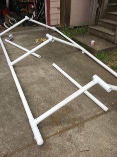 an upside down bed frame laying on the ground