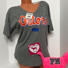 New With Tags Victoria’s Secret Pink Collegiate Collection University Of Florida Uf Gators T-Shirt Cut Out Logo Size Extra Small No Offers Please Casual V-neck Top For College, V-neck Spring College Tops, Sporty V-neck Top With Letter Print, Sporty V-neck T-shirt For Loungewear, College Graphic Print V-neck T-shirt, V-neck Graphic Print T-shirt For College, Casual Orange Tops For Game Day, Casual V-neck T-shirt For College, Sporty Orange Tops For Game Day