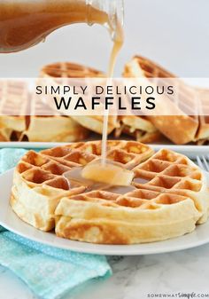 a plate with waffles and syrup being drizzled over them on the side