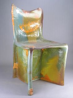 a chair made out of plastic sitting on top of a table