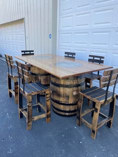 a table made out of wine barrels with chairs around it