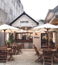 an outdoor cafe with umbrellas and chairs