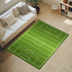 a living room with a soccer field rug on the floor and couch in front of it