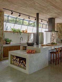 a kitchen with a stove, counter and chairs