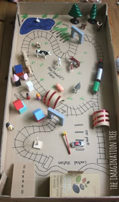 an open box with toys in it on the floor