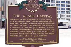 the glass capital sign is in front of some buildings