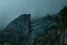 the mountains are covered in fog and clouds