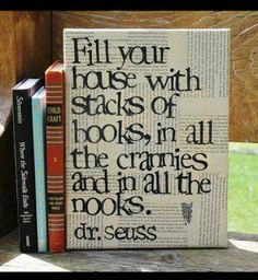 a stack of books sitting on top of a wooden table