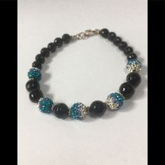 This Faceted Black Spinel Beaded Bracelet Has 5 Evenly Spaced Teal & Clear Crystal Beads. It Is Approx. 7 1/2”With Sterling Sterling Spacers And A Sterling Silver Lobster Claw Clasp. It Is A Cmf Original. Please Note That I Have Already Reduced Most Items From Their Original Selling Price And Because Most Of My Listings, Unless Otherwise Stated, Are New Never Worn, I Can Not Reduce Them Much More. Thank You For Your Interest. Black Crystal Bracelet With Faceted Beads For Party, Black Faceted Beads Crystal Bracelet For Party, Adjustable Black Crystal Bracelet With Silver Beads, Black Crystal Bracelet With Round Beads For Party, Black Crystal Bracelet With Silver Beads As Gift, Black Round Beads Bracelets For Party, Gift Black Crystal Bracelet With Silver Beads, Black Beaded Bracelets With Silver Beads For Party, Black Beaded Crystal Bracelet For Party