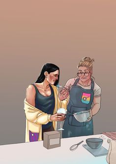 two women in aprons are cooking together