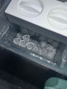 an open refrigerator door with ice in it