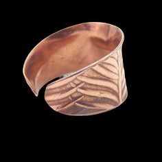 Add elegance and bohemian flair to your jewelry collection with our Handcrafted Copper Anticlastic Feather Cuff Ring. This stunning boho chic ring features a unique feather design making it the perfect statement piece for any outfit. At its widest point, this hand forged cuff ring measures 1/2 inch, ensuring a bold and eye-catching look on your finger. What's even better is that it is adjustable, so you can find the perfect fit for your finger.  Add this statement cuff ring to your copper jewelry collection. Each handmade artisan ring band is carefully packaged in a luxurious white organza bag making it an ideal gift for any occasion. Whether it's for a birthday, anniversary, holiday, or just to show someone you care, this ring is sure to make a lasting impression. We pride ourselves on pr Feather Cuff, Artisan Rings, Cuff Ring, Cuff Rings, Feather Design, Ring Band, Copper Jewelry, Handmade Artisan, Organza Bags