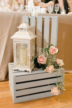 a white lantern sitting on top of a wooden crate