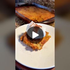 a white plate topped with food next to a pan