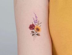 a woman with a flower tattoo on her arm