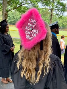 a woman wearing a pink hat with writing on it