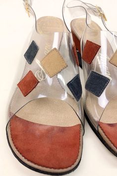 "DETAILS * the perfect mod wedge sandal * vinyl front with sewn on suede patches * peep toe * adjustable sling back * classic 60s mid century colors ERA: 1960s LABEL: Amano, Carefree Last SIZE: Marked an 8 but fit like a 7.5 Narrow width of ball foot: 3\" insole: approx 9.75\" heel: 2.5\" MATERIAL: vinyl, suede COLOR: clear, rust, beige, gray CONDITION: Excellent vintage condition. DISCLAIMER: Be aware that vintage shoes come in As Is condition. These shoes have been checked and tested to see if Retro Leather Wedge Heel Sandals, Retro Leather Open Toe Wedge Sandals, Retro Leather High Heel Wedge Sandals, Retro Leather Wedge Sandals, Retro High Heel Wedge Sandals, Retro Open Toe Wedge Sandals For Beach, Retro Wedge Heel Beach Sandals, Retro Wedge Sandals For The Beach, Retro Wedge Heel Sandals For Beach