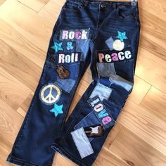 Upcycled patchwork jeans, Maurice's size 14 short, reworked denim hippie jeans.  These fun patch jeans have denim fabric patches along with the words "Peace, Love, Rock & Roll" and other various geometric patches.  This cute pair of  1970s-1980s vintage retro patched jeans would make a great outfit for a concert or festival, would be a great gift for a 70s-80s music lover...or keep for yourself if you have that  "hippie soul"! (WANT TO SEE MORE FROM THIS COLLECTION? Type RRPJ in this store's search field.) DETAILS: Size:  Women's size 14 short Brand:  Maurice's mid-rise Materials:  87% cotton, 12% polyester, 1% spandex MEASUREMENTS: Waist:  32 inches Hips:  40 inches Inseam:  28 inches Front Rise:  11 inches Back Rise:  16 inches Circumference bottom of leg:  17 inches Be sure to check the Retro Patchwork Denim Pants, Retro Denim Patchwork Pants, Hippie Denim Bottoms For Fall, Straight Leg Bottoms With Patches For Fall, Hippie Straight Leg Jeans For Fall, Fall Straight Leg Bottoms With Patches, Fall Season Straight Leg Bottoms With Patches, Fall Denim Bottoms With Patches, Bohemian Wide Leg Patchwork Jeans