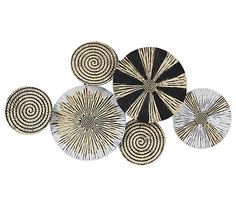 four black and white plates with spiral designs on the sides, all in different sizes