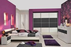 a bedroom with purple walls and white furniture