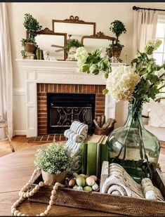 a living room filled with lots of furniture and flowers in a vase on top of a table