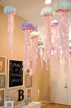 jellyfish decorations hanging from the ceiling in a room