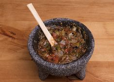 a bowl filled with soup sitting on top of a wooden table