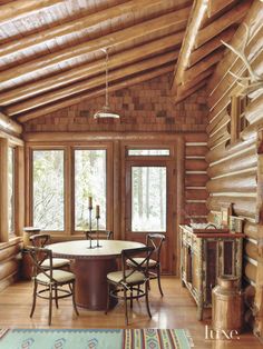 a dining room with wooden walls and flooring