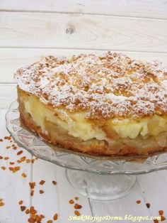 a cake sitting on top of a glass plate covered in powdered sugar