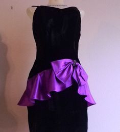 "This is a  fitted bombshell style dress made with luscious black velvet material and trimmed with a stunning purple satin peplum and a large bow trimmed in the center with a rhinestone brooch. Spaghetti straps and figure hugging style this is a classic retro 50s fashion that is revived every so often as is very flattering and a stunning style. Dress closes with a 16\" side zipper that works smooth as new Fabric is 100 percent rayon crushed velvet outer materi100 percent acetate satin lining. Th Purple Velvet Dress For Party, Purple Velvet Party Dress, Elegant Purple Velvet Dress, Formal Purple Velvet Dress, Purple Velvet Fitted Dress, Fitted Purple Velvet Dress, Elegant Purple Dress With Bow, Black Velvet Cocktail, Dress Peplum