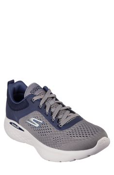 Mesh paneling allows your foot to breathe in a sporty sneaker from Skechers that's built on a supportive sole. Textile upper/synthetic lining and sole Imported Navy Round Toe Walking Shoes For Sports, Casual Navy Running Shoes With Air Cushioning, Navy Walking Shoes With Round Toe For Sports, Sporty Air Max Cushioned Sneakers For Walking, Synthetic Sneakers With Air Max Cushioning For Walking, Synthetic Air Max Cushioned Sneakers For Walking, Navy Running Shoes With Air Cushioning, Athletic Fit Walking Sneakers In Synthetic Material, Navy Sneakers For Jogging