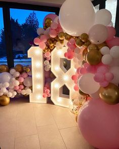 balloons and lights decorate the entrance to a birthday party