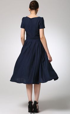 "This lovely pleated navy blue dress goes easily from day to night. With its square neckline, short sleeves and fitted waist. this charming midi linen dress flawlessly tailored from the finest quality linen blend, the pleats lay flat but still give the skirt a full swing. The perfect midi length for work or a semi formal event. DETAIL * 50% linen , 50% cotton blend * Classic and beautiful color * Fitted waist to show off your curves * Has no pockets (can't add) * Square neckline * Short sleeves Cotton Dress With Pleated Waist And Short Sleeves, Cotton Short Sleeve Dress With Pleated Waist, Navy A-line Cotton Dress, Navy Cotton A-line Dress, Summer Midi Dress With Box Pleat And Short Sleeves, Navy Linen Summer Dress, Navy Pleated Summer Dress, Summer Knee-length Midi Dress With Box Pleat, Pleated A-line Linen Dress