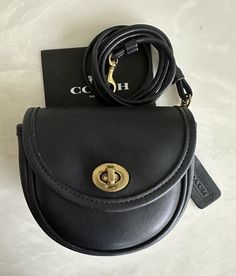 Coach vintage small belt bag black leather    flap with turn lock closure - unlined with slip pocket  coach creed 9826 solid brass hardware wear as a fanny pack/belt bag (belt not included) - 2nd to last photo for reference only! non-adjustable strap 23.5" drop for crossbody or shoulder wear coach embossed hangtag   made in the usa 1997 6 x 5 x 2" approx. dimensions cells will not fit in this bag condition - bag is in excellent condition - has been rehabbed, bathed and conditioned - inside is cl Classic Crossbody Belt Bag, Classic Belt Bag With Removable Pouch, Vintage Coach, Black Mini, Belt Bag, Cross Body Handbags, Vintage Black, Adjustable Straps, Solid Brass