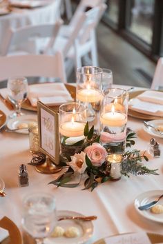 the table is set with candles and place settings