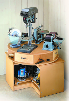 a sewing machine sits on top of a wooden table with drawers underneath it and an open drawer in the middle