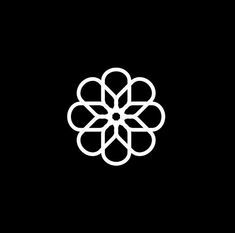 a black and white flower logo on a black background