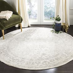 a large white rug in a living room with a green chair and window behind it