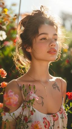 a woman with flowers on her shoulder and chest standing in front of some bushes, looking off to the side