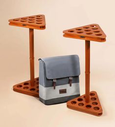 two wooden tables with one bag on top and the other sitting on it's sides