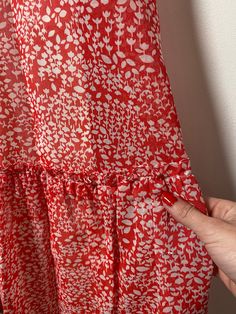 This floral maxi dress is the stuff of dreams! It is Union Made and from the 1970's, made predominantly of cotton and polyester. It's a gorgeous dress and perfect for spring and summer! It is a coral pink color with a white floral pattern on it. It is closest to a modern day size 2/4, but here are the exact measurements taken lying flat and doubled: Shoulders: 15 inches Chest: 28 inches Waist: 24 inches Hips: 30 inches Shoulders to Hem: 50 inches This dress has an inner lining too, so it keeps i Red Retro Maxi Dress For Summer, Vintage Red Maxi Dress For Vacation, Red Vintage Maxi Dress For Vacation, Red Ruffled Maxi Dress For Spring, Red Retro Maxi Dress For Spring, Retro Red Maxi Dress For Spring, Red Sundress Maxi Dress For Spring, Red Floral Print Maxi Dress For Spring, Coral Pink Color