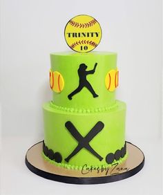 a three tiered cake decorated with green frosting and black fondant baseballs