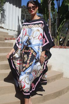 Designer print kaftan for dressy or casual wear.  Take on that cruise or just enjoy lounging elegantly or entertaining at home. One size.  Fits many sizes small to X-large.  The width is 52 inches, edge to edge, 104 around the body.  The side seams are 6 inches from the edge.  The length is 51 inches.  Machine wash on short, delicate cycle or hand wash. Chic Silk Kaftan For Beach Cover-up, Chic Tunic Kaftan For Vacation, Elegant Flowy Kaftan For Vacation, Black Silk Maxi Dress For Vacation, Elegant Printed Beach Kaftan, Chic Multicolor Kaftan With Kimono Sleeves, Chic Flowy Tunic Kaftan, Chic Black Tunic Kaftan, Chic Long Kaftan For Beach Season