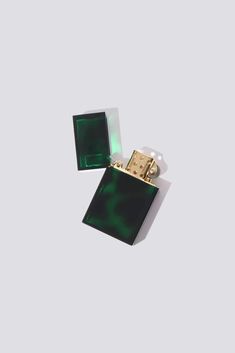 an emerald green lighter sitting on top of a white surface