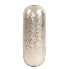 a silver vase sitting on top of a white table