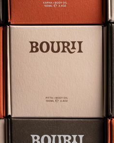 four bottles of bourri are stacked on top of each other in different colors