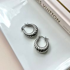 Add a touch of fun to your look with our Twisted Hallow Croissant Hoop Earrings! These earrings are not only light weight, but also incredibly cute and will never go out of style. Perfect for any occasion, these hoops will bring a playful twist to any outfit. They are made to last , hypoallergenic and waterproof 18K PVD Gold Plated 316L Stainless Steel 20mm Jewelry Inspo, Silver Hoop Earrings, Go Out, Out Of Style, Gold Earrings, Silver Earrings, Going Out, Gold Plate, Hoop Earrings