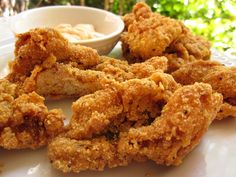 fried food on a plate with dipping sauce